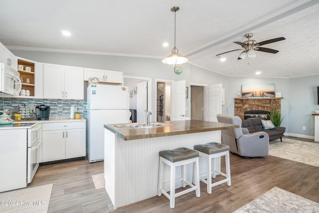 kitchen featuring white cabinetry, sink, and light wood-type flooring