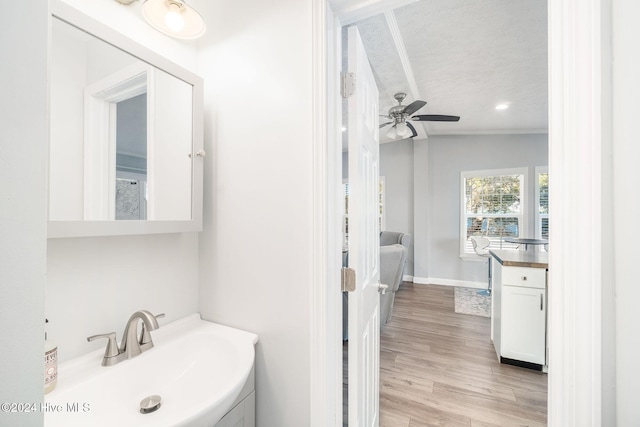 bathroom featuring ceiling fan, vanity, lofted ceiling, and hardwood / wood-style flooring