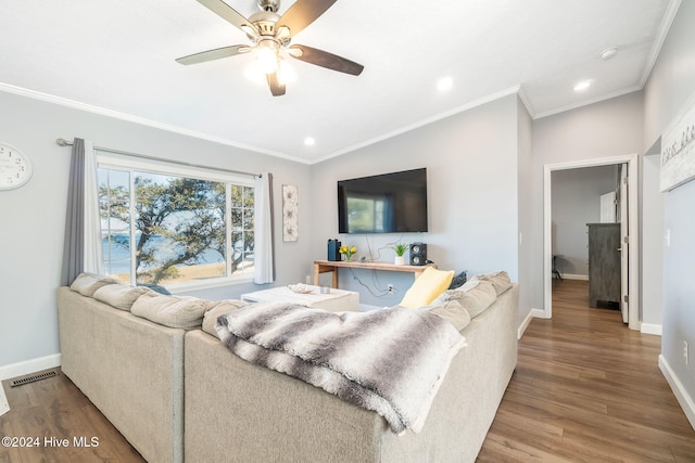 living room featuring hardwood / wood-style floors, ceiling fan, and ornamental molding