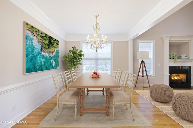 dining space featuring hardwood / wood-style floors, a notable chandelier, and ornamental molding