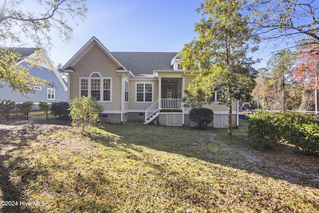 back of house with a lawn