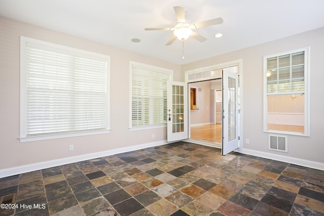 unfurnished room featuring french doors and ceiling fan