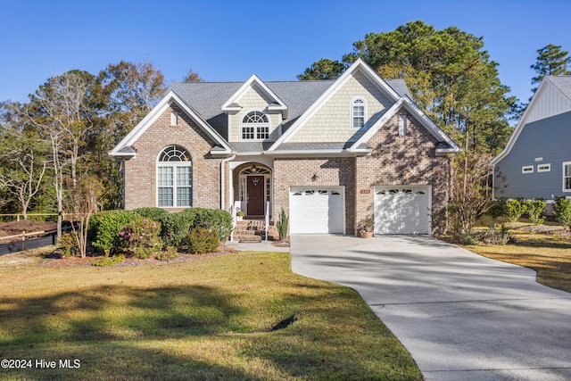 view of front of home with a garage and a front lawn