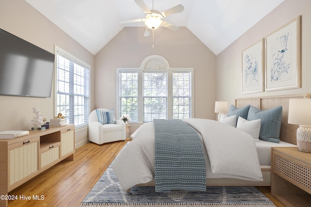 bedroom featuring ceiling fan, light hardwood / wood-style floors, and vaulted ceiling