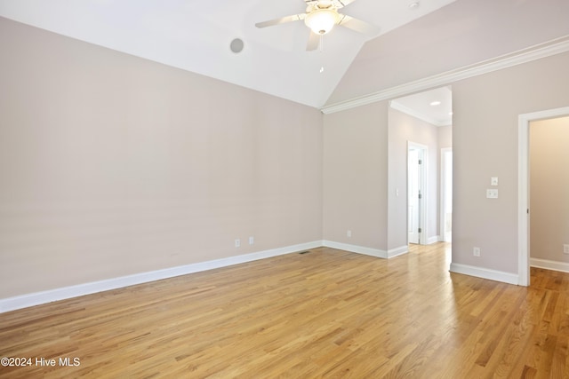 empty room featuring light wood-type flooring, vaulted ceiling, ceiling fan, and crown molding