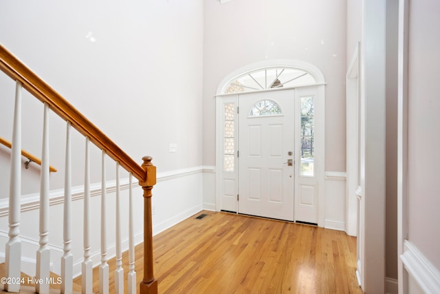 entrance foyer featuring a high ceiling and light hardwood / wood-style flooring