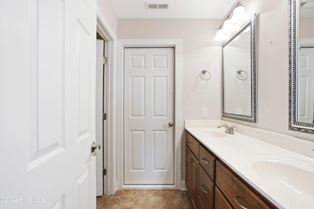 bathroom featuring tile patterned flooring and vanity