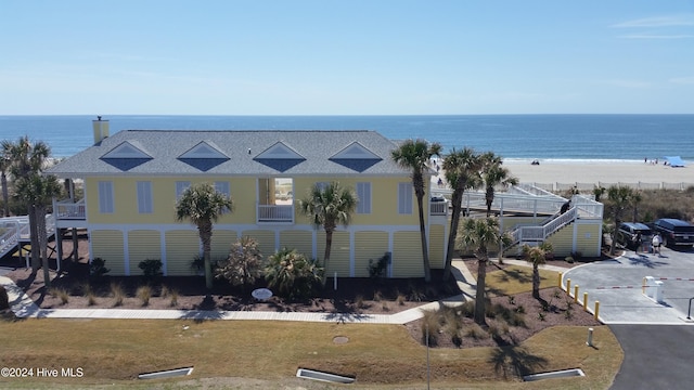 exterior space featuring a view of the beach and a water view