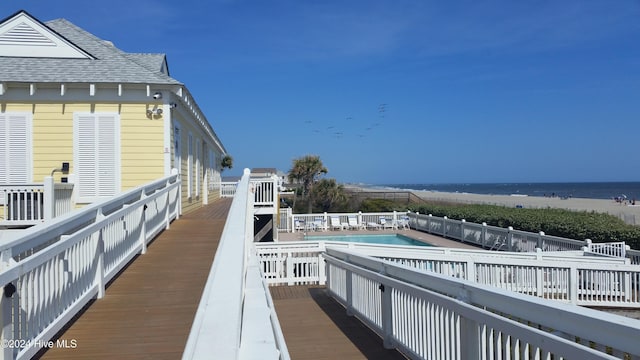 exterior space featuring a deck with water view