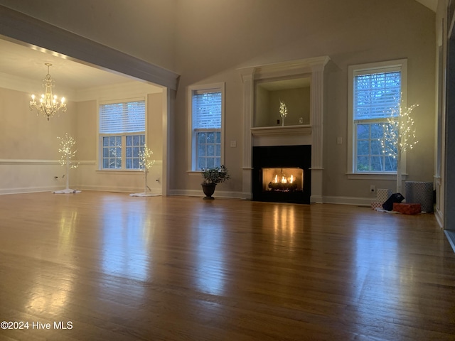 unfurnished living room with dark hardwood / wood-style flooring and a wealth of natural light