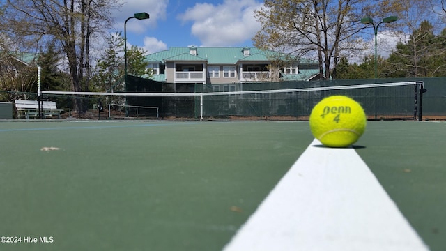 view of property's community with tennis court