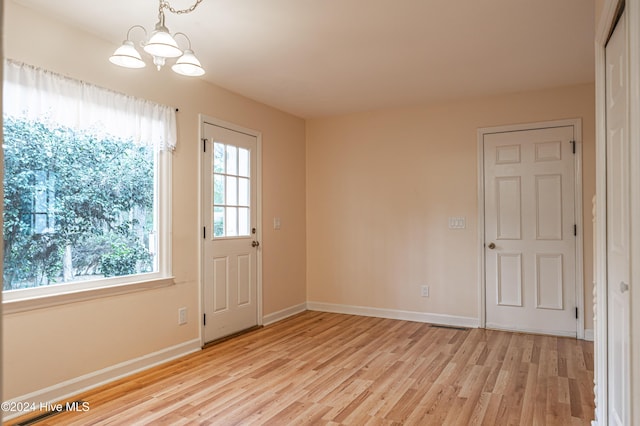 102 James Creek Rd, Southern Pines, NC 28387 - doorway with a chandelier, light wood-style floors, and baseboards