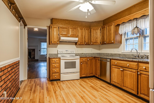 102 James Creek Rd, Southern Pines, NC 28387 - kitchen featuring white electric stove, stainless steel dishwasher, under cabinet range hood, brown cabinetry, and a sink
