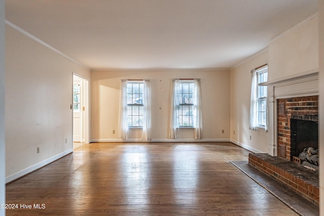102 James Creek Rd, Southern Pines, NC 28387 - unfurnished living room with ornamental molding, healthy amount of natural light, wood finished floors, a brick fireplace, and baseboards