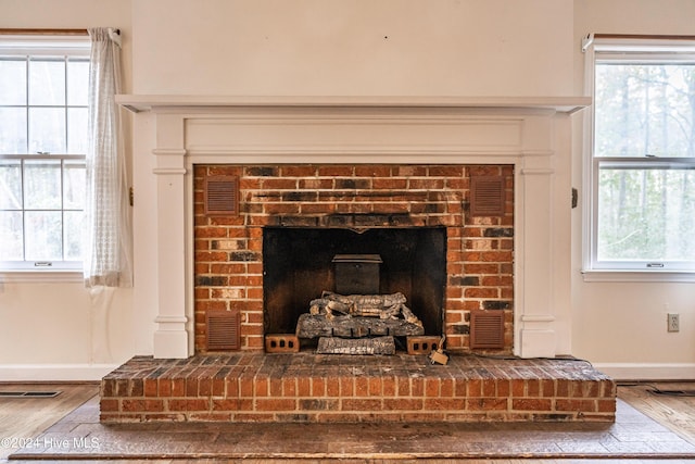 102 James Creek Rd, Southern Pines, NC 28387 - detailed view of a brick fireplace, wood finished floors, and baseboards