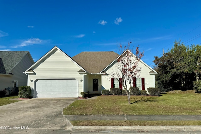 view of front of house featuring a garage and a front lawn