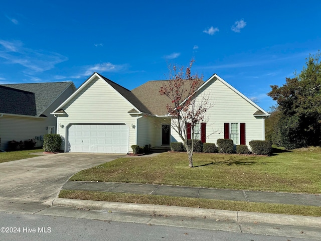 view of front of home with a garage and a front lawn