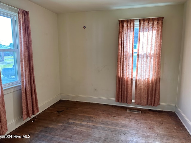 empty room featuring dark wood-type flooring