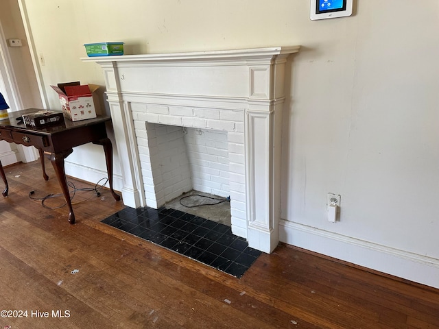 interior details with a brick fireplace and hardwood / wood-style flooring