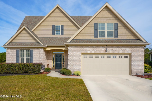 view of front of home featuring a front yard and a garage