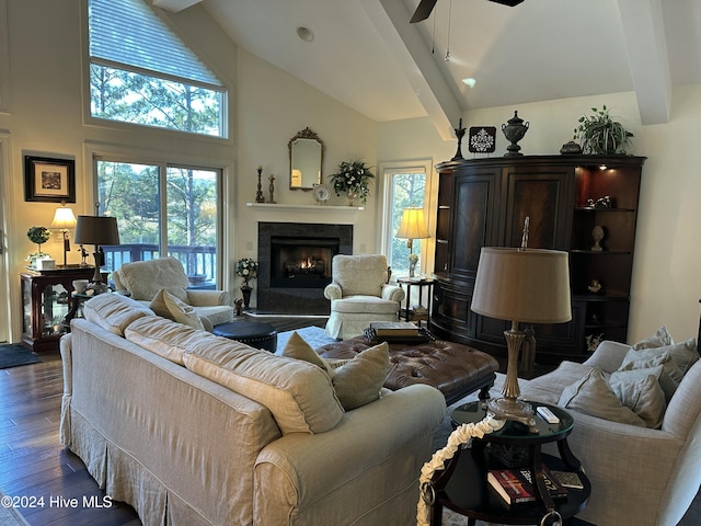 living room featuring dark hardwood / wood-style flooring, ceiling fan, beamed ceiling, and a high ceiling