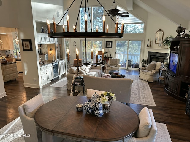 dining space with dark hardwood / wood-style floors, high vaulted ceiling, beverage cooler, ceiling fan, and a high end fireplace