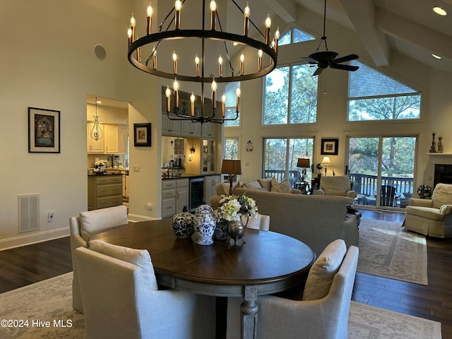 dining area with hardwood / wood-style flooring, beverage cooler, beamed ceiling, and a towering ceiling