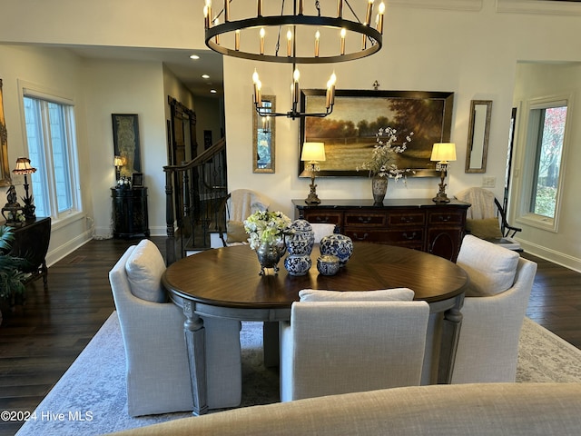 dining area featuring dark hardwood / wood-style floors and a notable chandelier