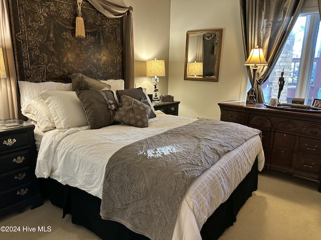 bedroom featuring light colored carpet