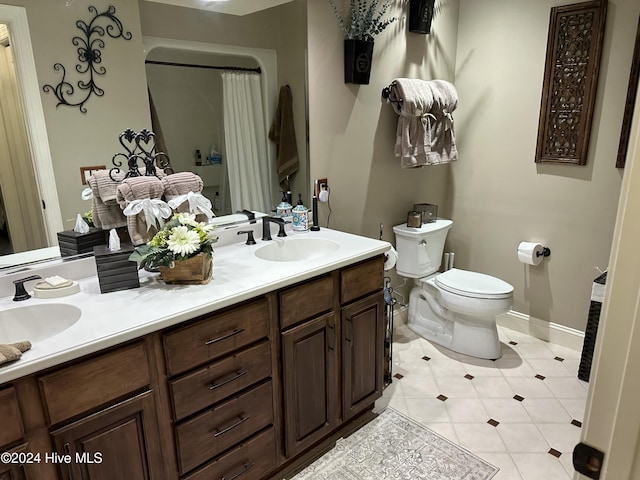 bathroom with tile patterned floors, vanity, and toilet