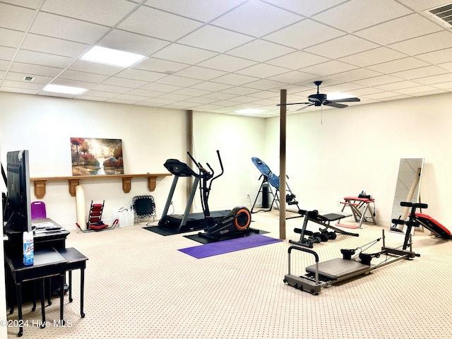 exercise area featuring carpet, a drop ceiling, and ceiling fan