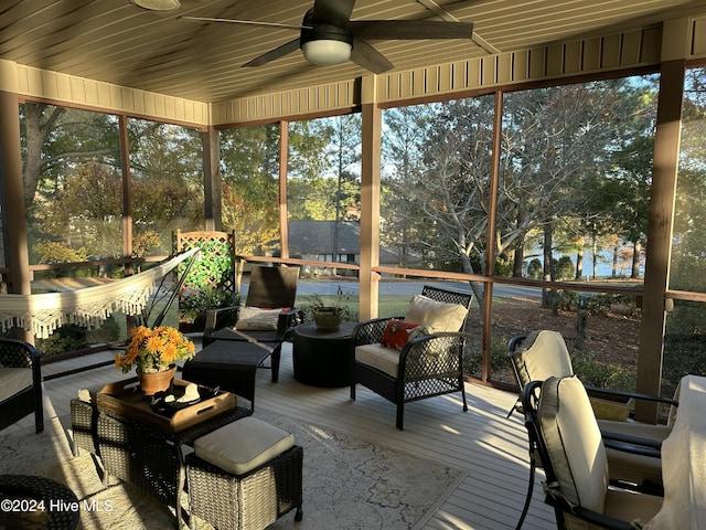 sunroom / solarium with plenty of natural light, wooden ceiling, and ceiling fan