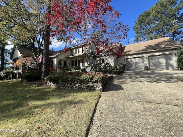 view of front of house with a garage and a front yard