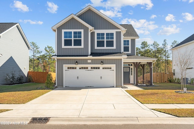 view of front of home featuring a front yard and a garage