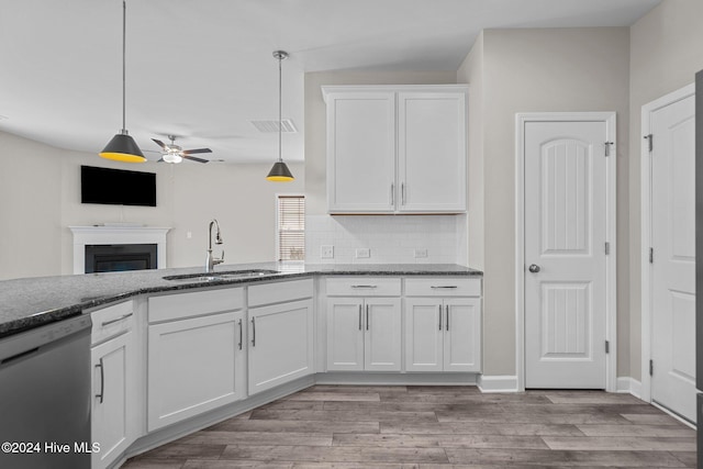 kitchen with white dishwasher, sink, ceiling fan, decorative light fixtures, and white cabinetry