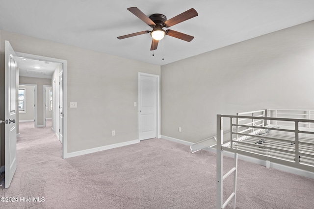 unfurnished bedroom featuring ceiling fan and light colored carpet