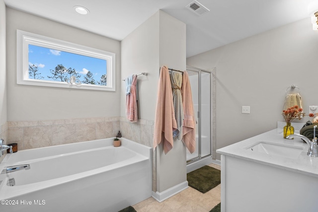 bathroom with tile patterned floors, vanity, and independent shower and bath