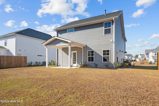 back of house with a lawn