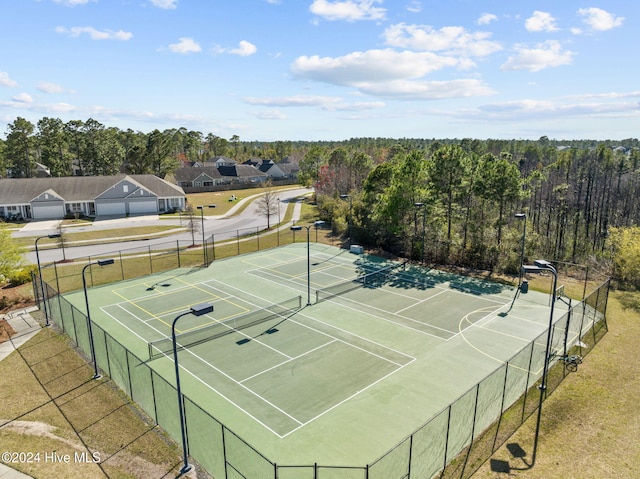 view of tennis court featuring basketball hoop