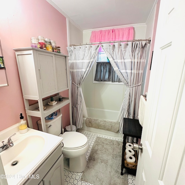 bathroom with tile patterned floors, vanity, toilet, and ornamental molding