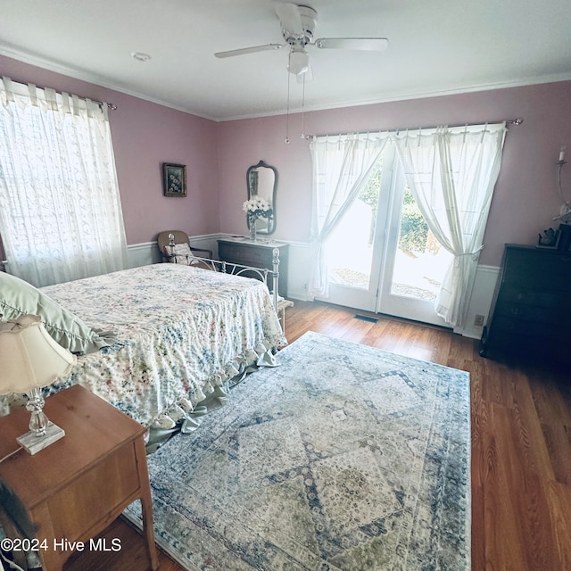 bedroom featuring hardwood / wood-style flooring, ceiling fan, crown molding, and access to outside