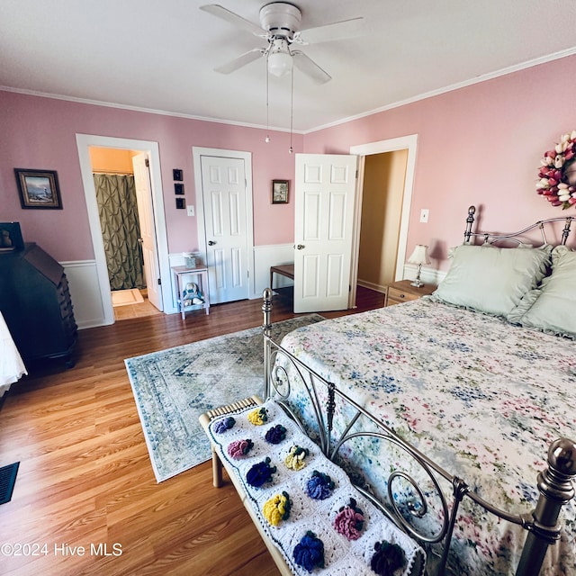 bedroom with ceiling fan, wood-type flooring, crown molding, and ensuite bath