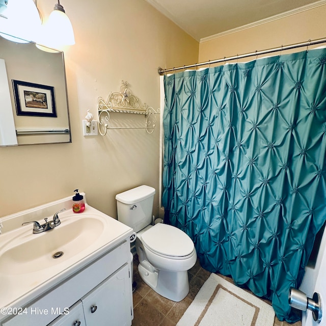 bathroom featuring tile patterned flooring, vanity, curtained shower, and toilet