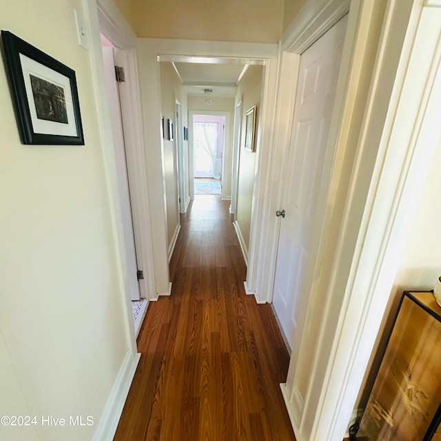 hall with dark hardwood / wood-style flooring