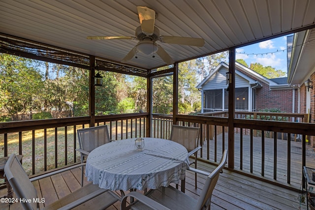 deck with a sunroom and ceiling fan