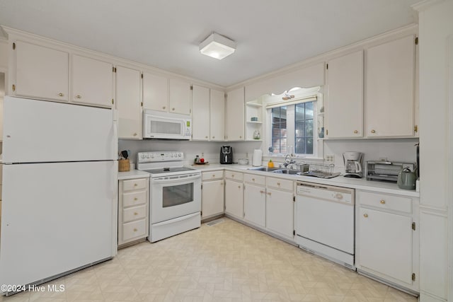 kitchen featuring white cabinetry, white appliances, and sink