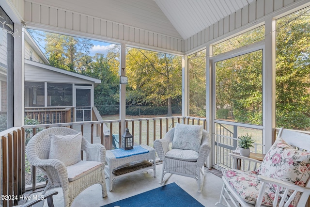 sunroom / solarium featuring plenty of natural light and lofted ceiling