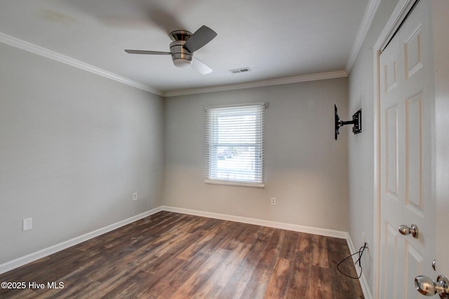 empty room with ceiling fan, dark hardwood / wood-style floors, and ornamental molding