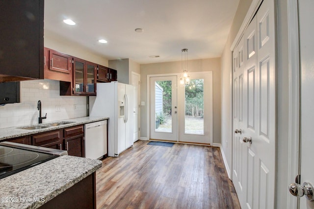 kitchen with french doors, white appliances, sink, light hardwood / wood-style floors, and hanging light fixtures