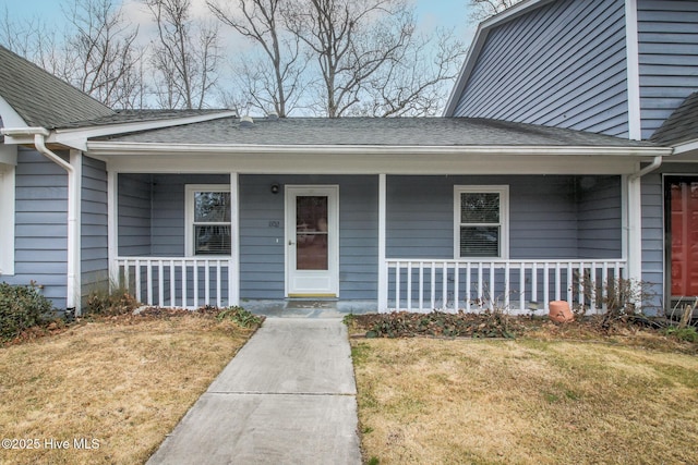 entrance to property with a lawn